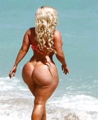 A woman with a large butt walking on the beach.