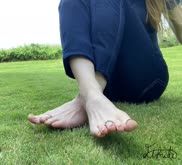 Peachy toes in the dewey grass