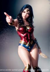 a woman dressed as wonder woman points at the camera . 