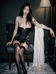 a woman in black lingerie sitting on a chair . 