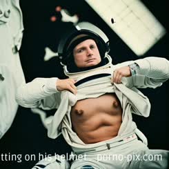 a man in a spacesuit is putting on his helmet . 