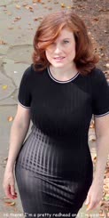 Redheaded woman in all black walks down sidewalk, time for a pettiest and a thumb