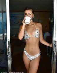 Coffee, bikini, and a door: A picture of a woman drinking coffee in a bikini outside of a door