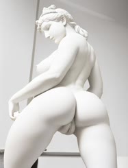 a white statue of a woman with a bare bottom