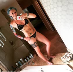 A woman taking a selfie in a bikini with tattoos would be a good short naughty title!