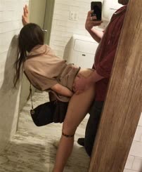 Woman in a bathroom getting fucked by a man