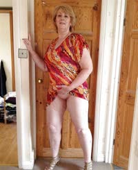 Sultry Blonde MILF Exposes Her Naked Legs and Thighs in a Sizzling Doorway Display