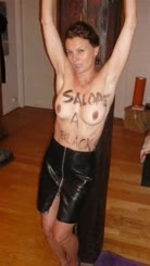  A woman with no shirt on, breasts showing, has a sign on her that says salde.