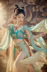 a woman in a blue and gold costume is dancing