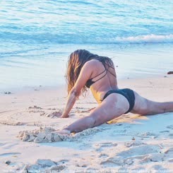 Handstand on Sand Beach: A Woman in a Bikini Doing a Handstand