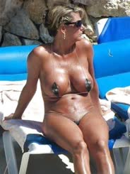 Sunbathing Naked Woman with Large Breasts