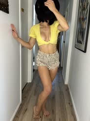 Sultry Stroll: A Busty Babe in a Yellow Bra and Shorts