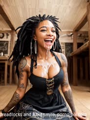 a woman with dreadlocks and a big smile 