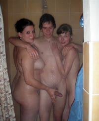  Three naked women in a shower taking a picture of themselves.