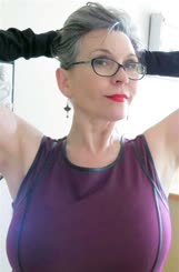Sultry Lady in Purple Dress and Glasses Posing for a Sensual Photo
