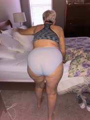 Old lady wearing underwear showing through bed sheet
